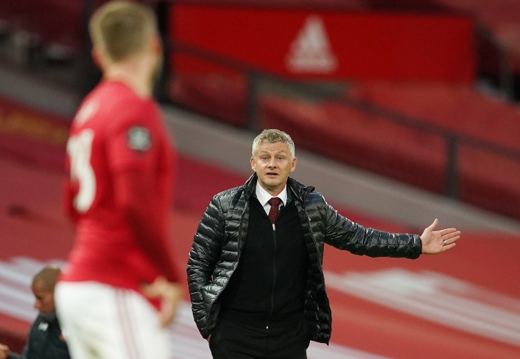 Ole Gunnar Solskjaer talking to his player from the sideline during a Premier League match