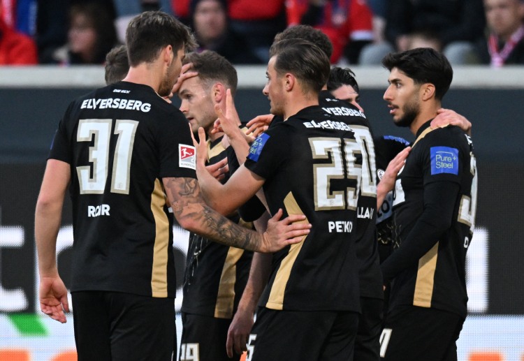 Lukas Petkov shares a celebratory moment with teammates during their Bundesliga relegation clash with FC Heidenheim